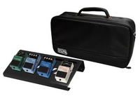 BLACK SMALL ALUMINUM PEDAL BOARD WITH GATOR CARRY BAG AND BOTTOM MOUNTING POWER SUPPLY BRACKET.